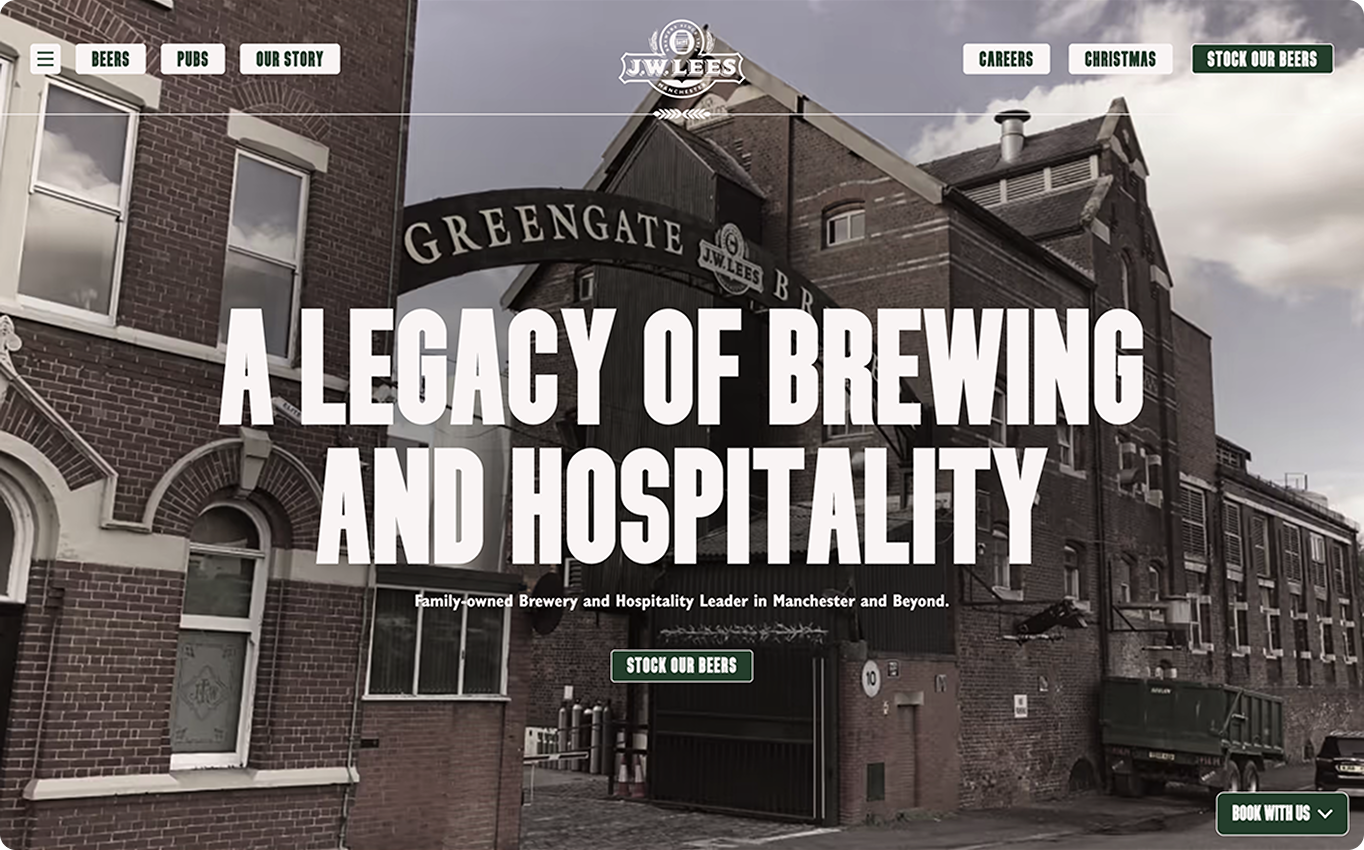 A brewery, showcasing its history, is situated in a brick industrial area. "A LEGACY OF BREWING AND HOSPITALITY. Family-owned Brewery and Hospitality Leader in Manchester and Beyond.